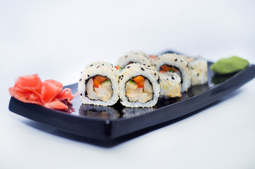 sushi rolls with wasabi and ginger cheese with salmon and sesame.