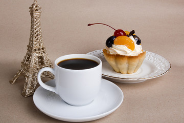 Cup of coffee, cake and the Eiffel Tower