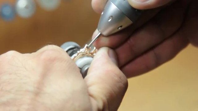Manual setting of the precious stones in jewelry. Production and making manufacturing, factory, cast craft design, process precious gold jewelry, diamond, jewels, ring jeweler, goldsmith in workshop.