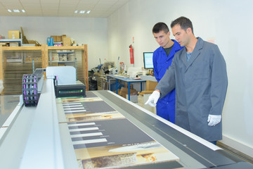 Two men working in professional printers