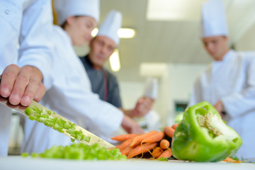 Peppers being wiped off blade of knife