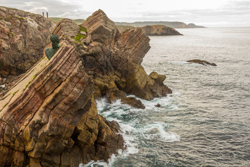 Monument on the rocks by the sea of Philippe Cousteau, Gijon, Spain