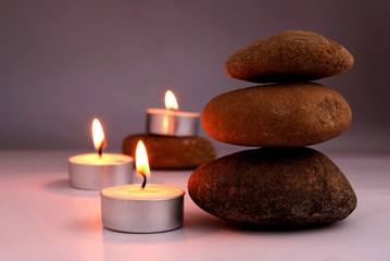 Fototapeta na wymiar stone balance and candle flame