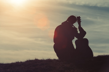 Girl with guitar in the grass