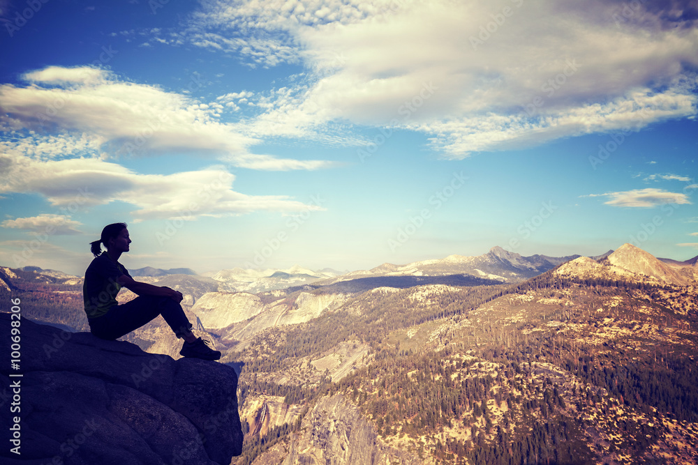 Wall mural vintage stylized silhouette of a woman watching mountain view.