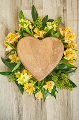 Valentines Day wooden heart/Pink wooden heart and flowers with place for text on the wooden background
