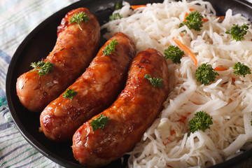 Sauerkraut with sausages on the table close-up. horizontal

