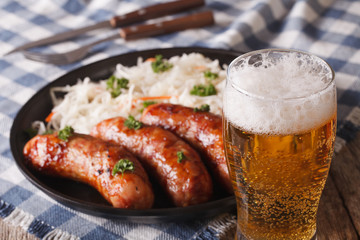 Lager beer and snacks of sausages and sauerkraut 
