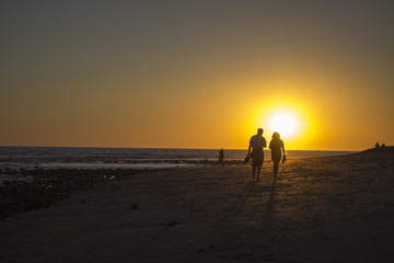 Fototapeta na wymiar A Couple Walking In Malibu Beach Sunset