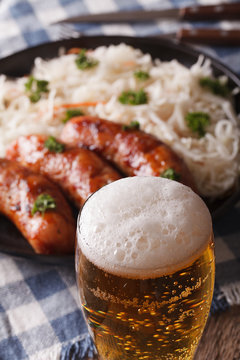 beer on a background of snack sausages and sauerkraut. Vertical
