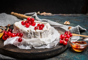 Camembert cheese plate with red berries, side view