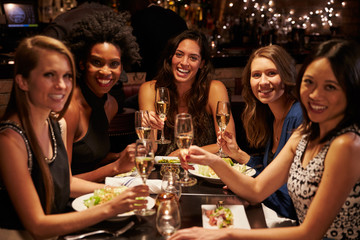 Group Of Female Friends Enjoying Meal In Restaurant