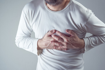Severe heartache, man suffering from chest pain, having painful