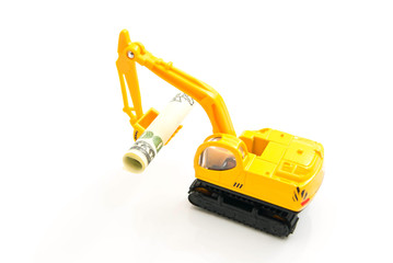 Fototapeta premium dollars banknotes and yellow backhoe