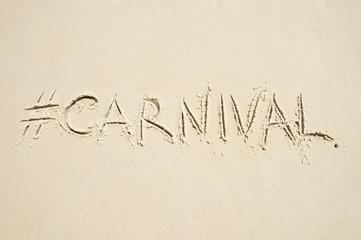 Hashtag social media message for carnival (spelled carnaval in Portuguese) written in smooth sand on the beach in Rio de Janeiro, Brazil