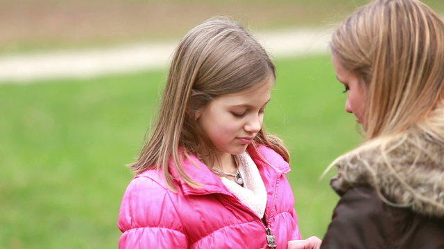 Mother zipping up daughter's jacket