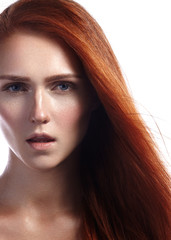 Beautiful ginger young woman with flying hair and naturel makeup. Beauty portrait of sexy model with straight red hair. Long soft shiny hairstyle. Close-up studio shot o fashion look redhead girl