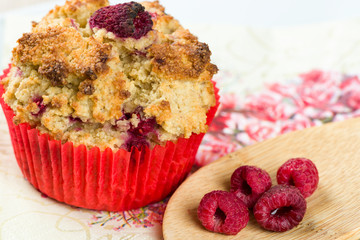 Raspberry cupcake with decoration on napkin