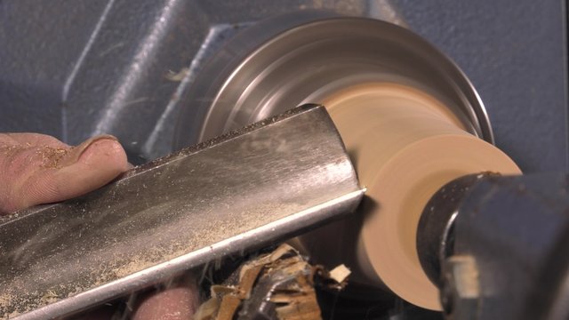 wood turner cutting shapes in wood
