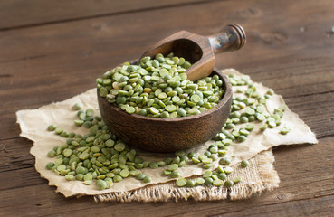 Uncooked Green Split Peas in a bowl  with a spoon