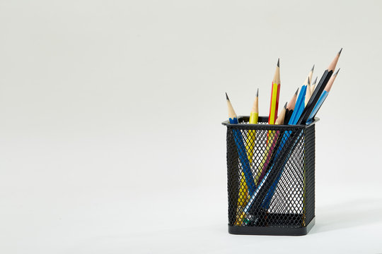 Pencils In Metal Pot On A White Background