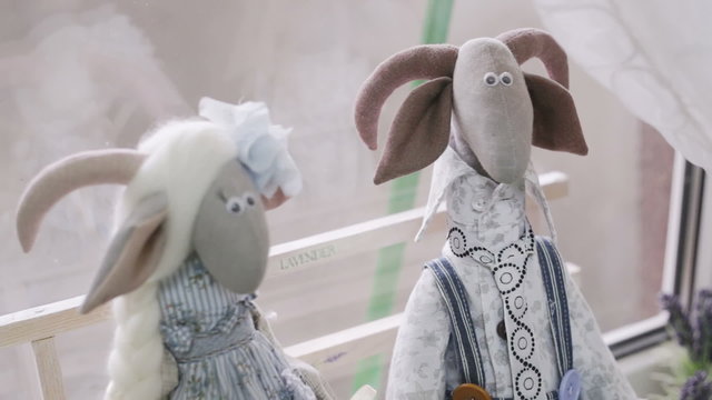Handmade goat toy. Goat of the scapegoat sitting on the windowsill