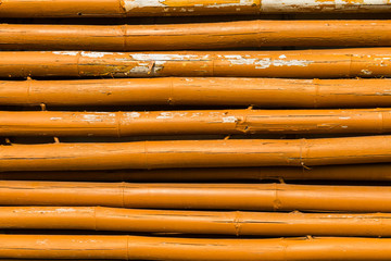 Closeup of the old and weathered yellow paint bamboo