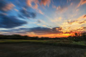 Zoom blur light sunset and clouds ,blue sky used as background