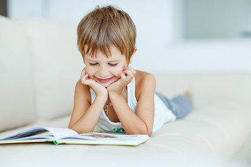School boy are reading the book at home 