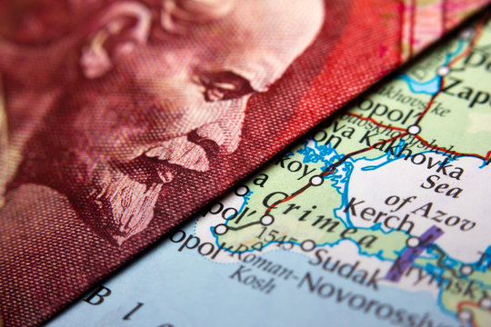 Close-up of an Russian ruble banknote (figuring Lenin) and a map showing Crimea (Crim)