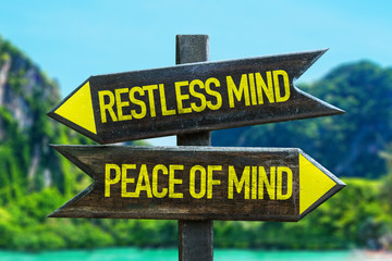 Restless Mind - Peace of Mind signpost in a beach background