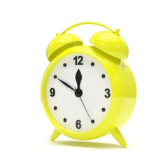 Yellow alarm clock on white
