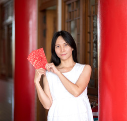 Asian lady holding red envelope or Ang-pow .