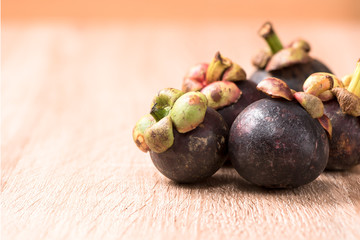 Fresh mangosteen fruit on wood table