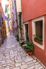 Fototapeta na wymiar Narrow Street With Hanging Clothes-Rovinj, Croatia