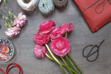 Some peonies with red gift pack and vintage scissors