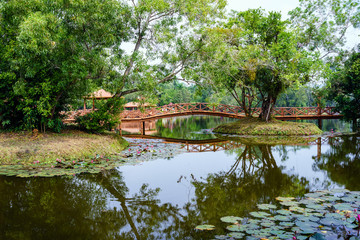 Beautiful garden with bridge and reflection in the lake