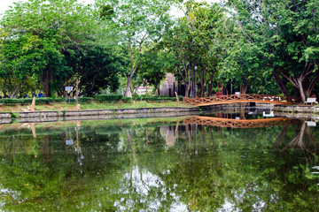 Fototapeta na wymiar Beautiful garden with bridge and reflection in the lake