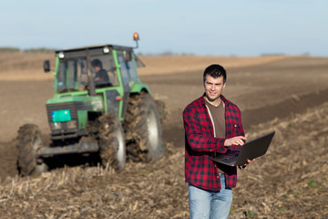 Farmer with laptop in the field