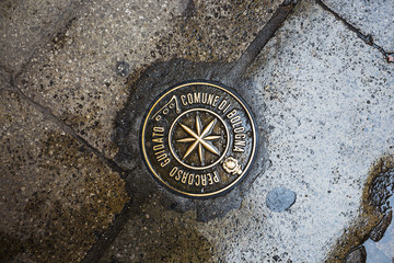  Metal sign for the walking tour embedded in pavement