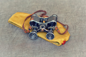 Vintage binoculars and Soviet military garrison cap with a red star, items World War II