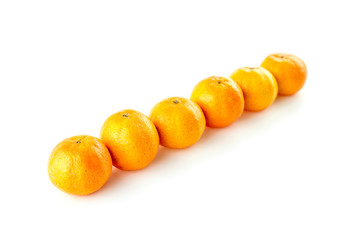 Diagonal line of oranges with copyspace against white