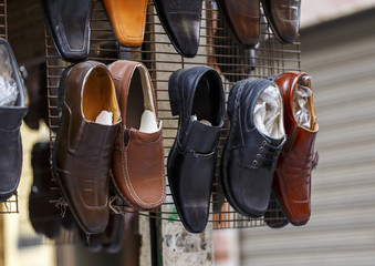 Men leather shoes in street market.