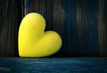 Fluffy heart on wooden texture