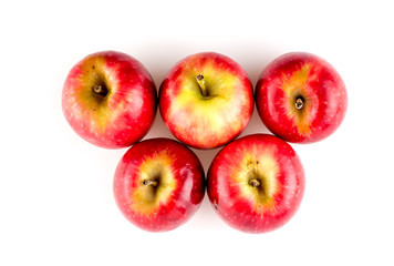 Top view of five apples with stems against white