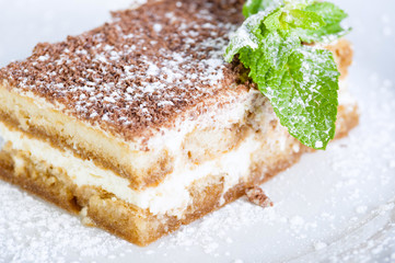 Tiramisu with strawberry, chocolate and powdered sugar