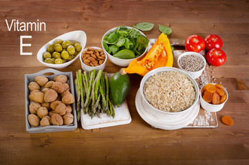 Foods high in vitamin E on a wooden table.