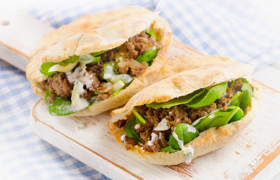 Pita bread with meat and fresh vegetables.