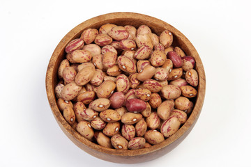 pinto beans on wood bowl 