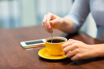 close up of woman with smartphone and coffee